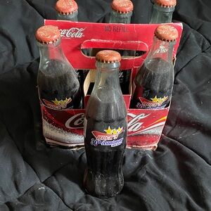 Coca-Cola Huck's 80th Anniversary Bottles with Red and Black Design